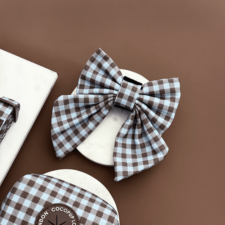 A brown and blue check print sailor bow tie for dogs. With velcro fastening.
