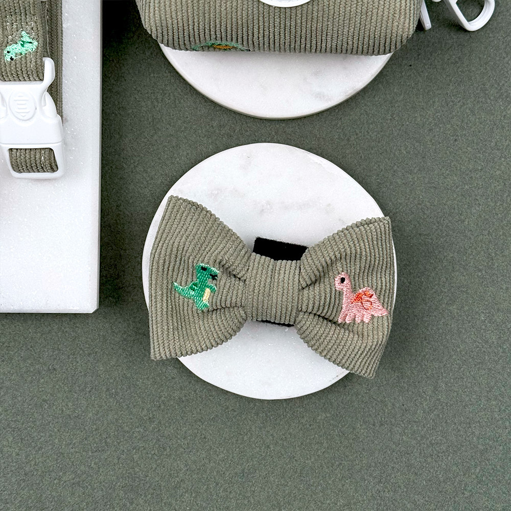 Green corduroy material Dog Bow Tie with embroidered dinosaurs. 