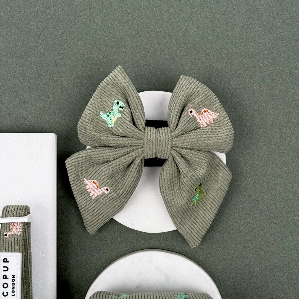 Green corduroy material Dog Sailor Bow Tie with embroidered dinosaurs. 