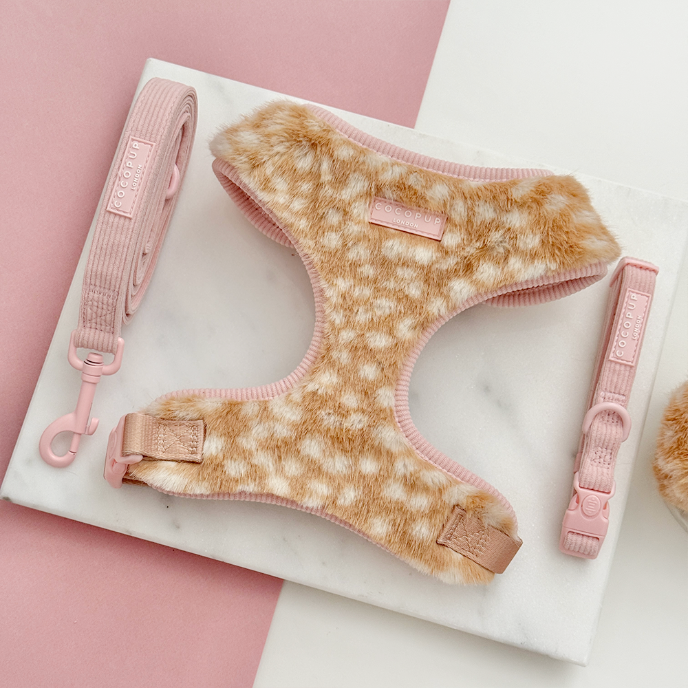 Faux fur dog harness in a beige and cream fawn pattern with pink ribbed lead and collar.