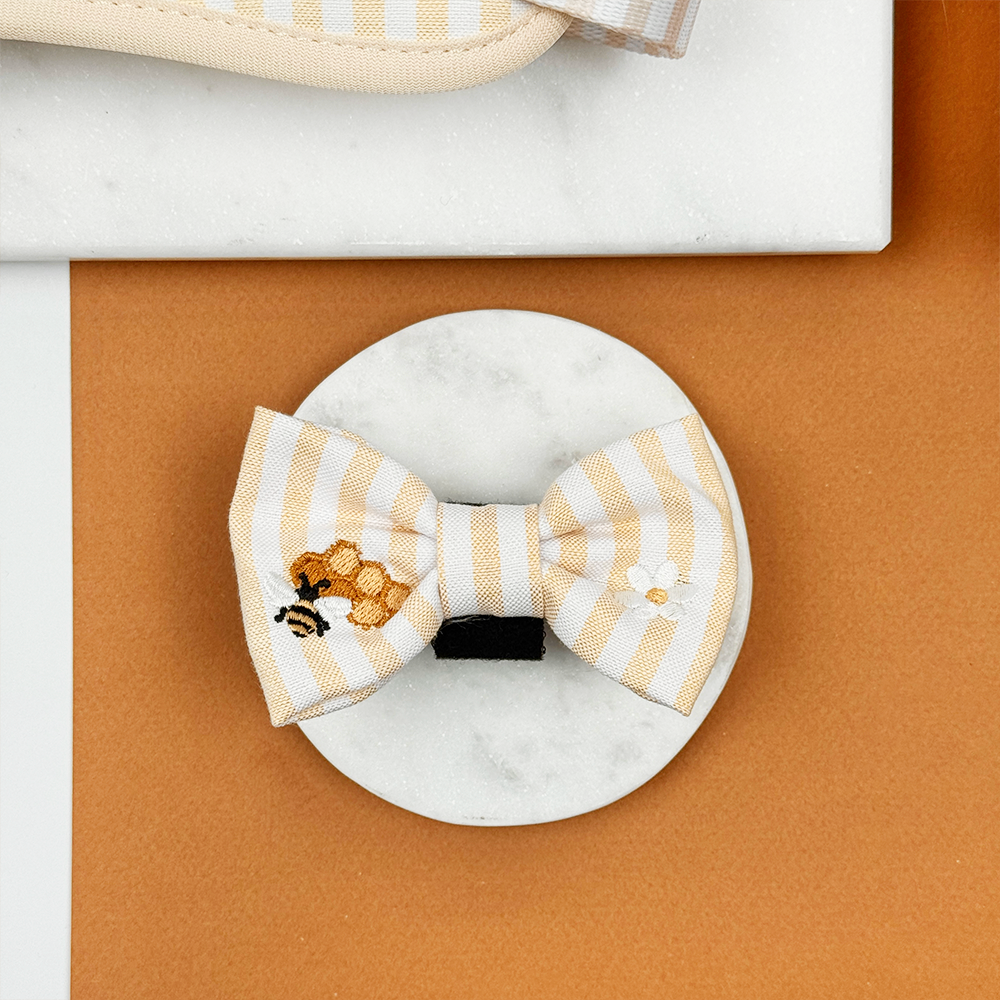 Pale yellow and white striped Dog Bow Tie with bee and honeycomb embroidered decals. 