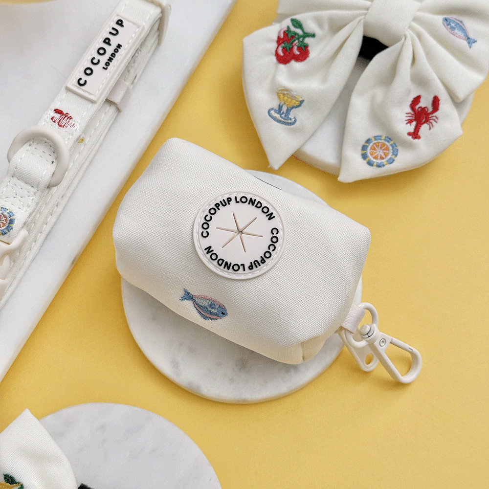 White linen fabric Dog Poop Bag Holder with summer embroidered embellishments.
