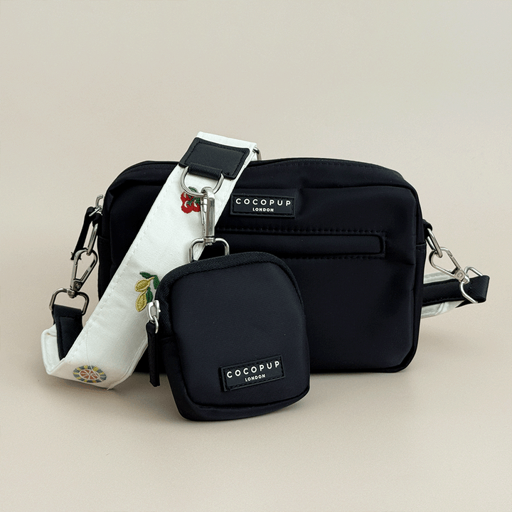 Cocopup Black Dog Walking Bag & small Treat Pouch, with white Bag Strap attached which has embroidered icons of lemons, tomatoes and more. 