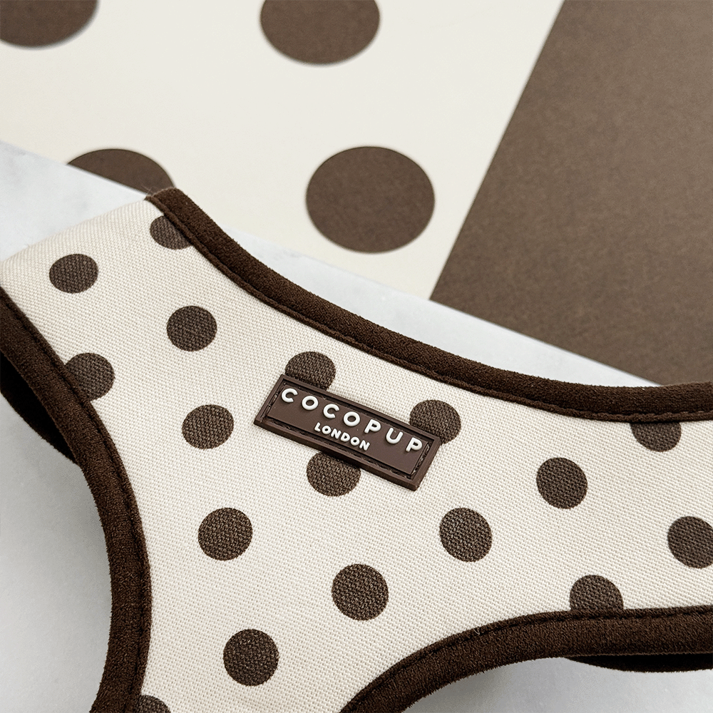 Dog harness with brown polka dots and 'Cocopup London' label on a neutral background