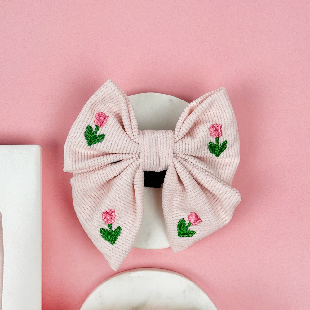 Pink dog bow tie with tulip embroidery.